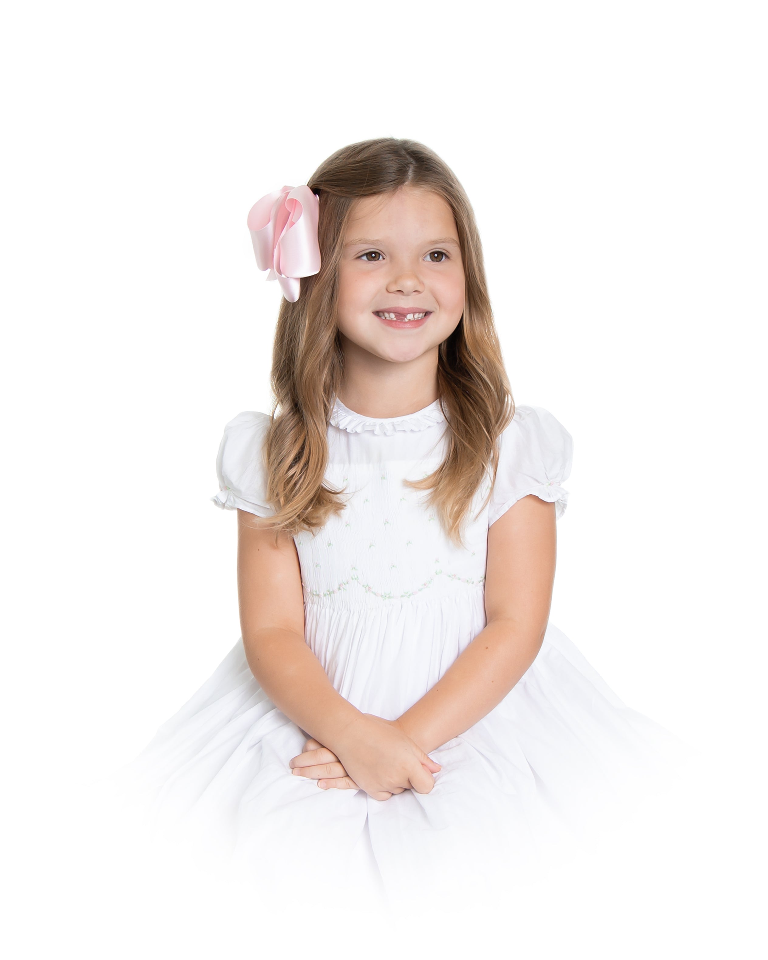 Charlotte sy Dimby classic timeless traditional smocked dresses for babies and girls handmade French style children clothing paris boutique twirling princess dress white heirloom elegant portrait dress houston texas born and raised studio photography vignette